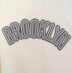 NBA BROOKLYN NETS REVERSE FRENCH TERRY MEN'S DROP SHOULDER FLEECE CREWNECK (EGGSHELL)