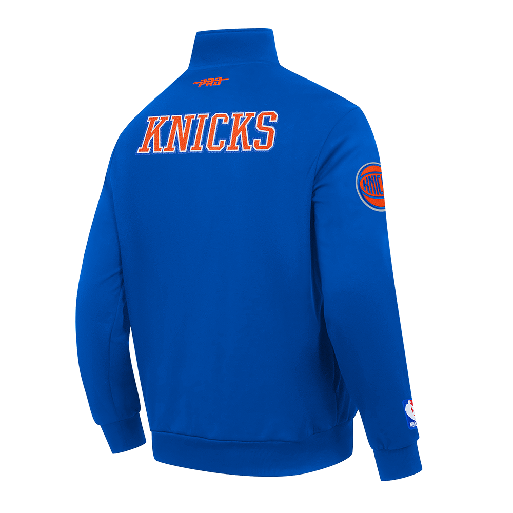 NBA NEW YORK KNICKS CITY ARCH HAUT EN MOLLETON À GLISSIÈRE AU QUART POUR HOMME (BLEU ROYAL)