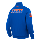NBA NEW YORK KNICKS CITY ARCH HAUT EN MOLLETON À GLISSIÈRE AU QUART POUR HOMME (BLEU ROYAL)