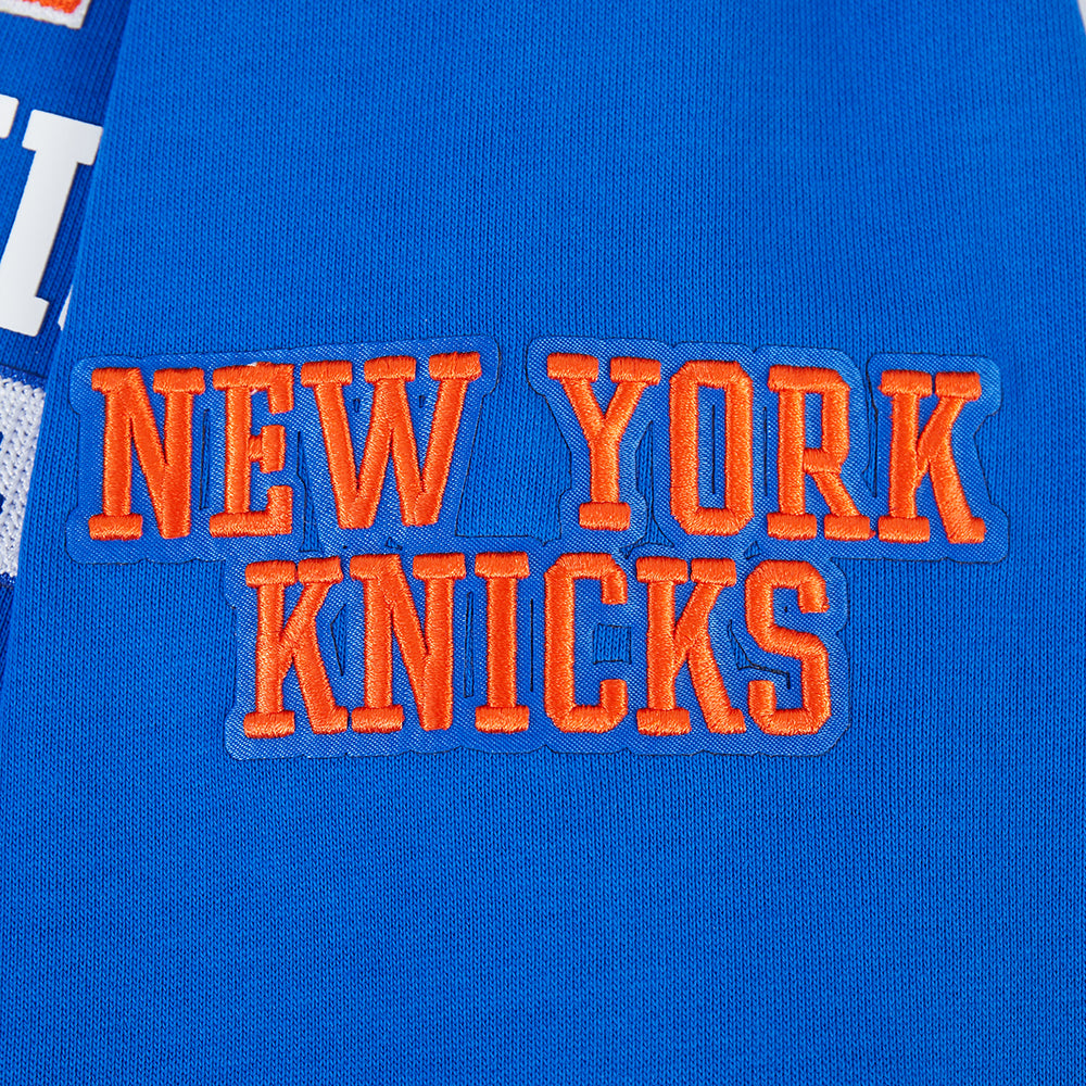 NBA NEW YORK KNICKS CITY ARCH HAUT EN MOLLETON À GLISSIÈRE AU QUART POUR HOMME (BLEU ROYAL)