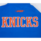 NBA NEW YORK KNICKS CITY ARCH HAUT EN MOLLETON À GLISSIÈRE AU QUART POUR HOMME (BLEU ROYAL)