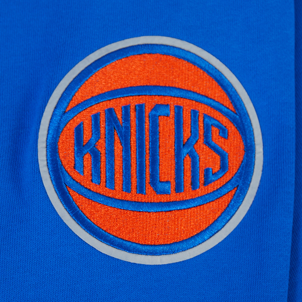 NBA NEW YORK KNICKS CITY ARCH HAUT EN MOLLETON À GLISSIÈRE AU QUART POUR HOMME (BLEU ROYAL)