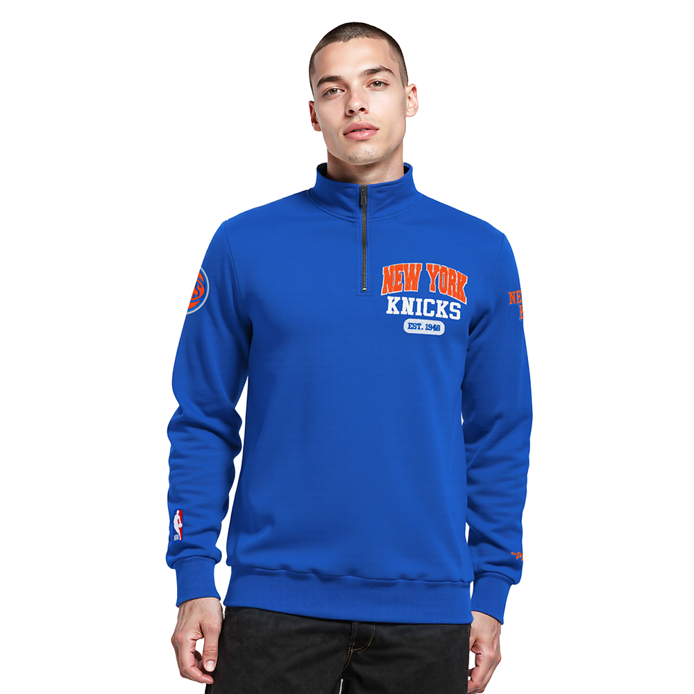 NBA NEW YORK KNICKS CITY ARCH HAUT EN MOLLETON À GLISSIÈRE AU QUART POUR HOMME (BLEU ROYAL)