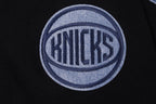 NBA NEW YORK KNICKS VARSITY BLUES MEN'S PULLOVER HOODIE (BLACK)
