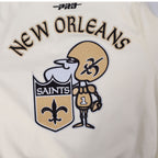 NFL NEW ORLEANS SAINTS BLOUSON RÉTRO PRO GAME DAY (COQUILLE D'ŒUF/TAUPE/COQUILLE D'ŒUF)